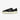 Side view of a black low-top canvas sneaker with cream-colored rubber sole and metallic eyelets, designed in a retro tennis shoe style for men, on a white background.
