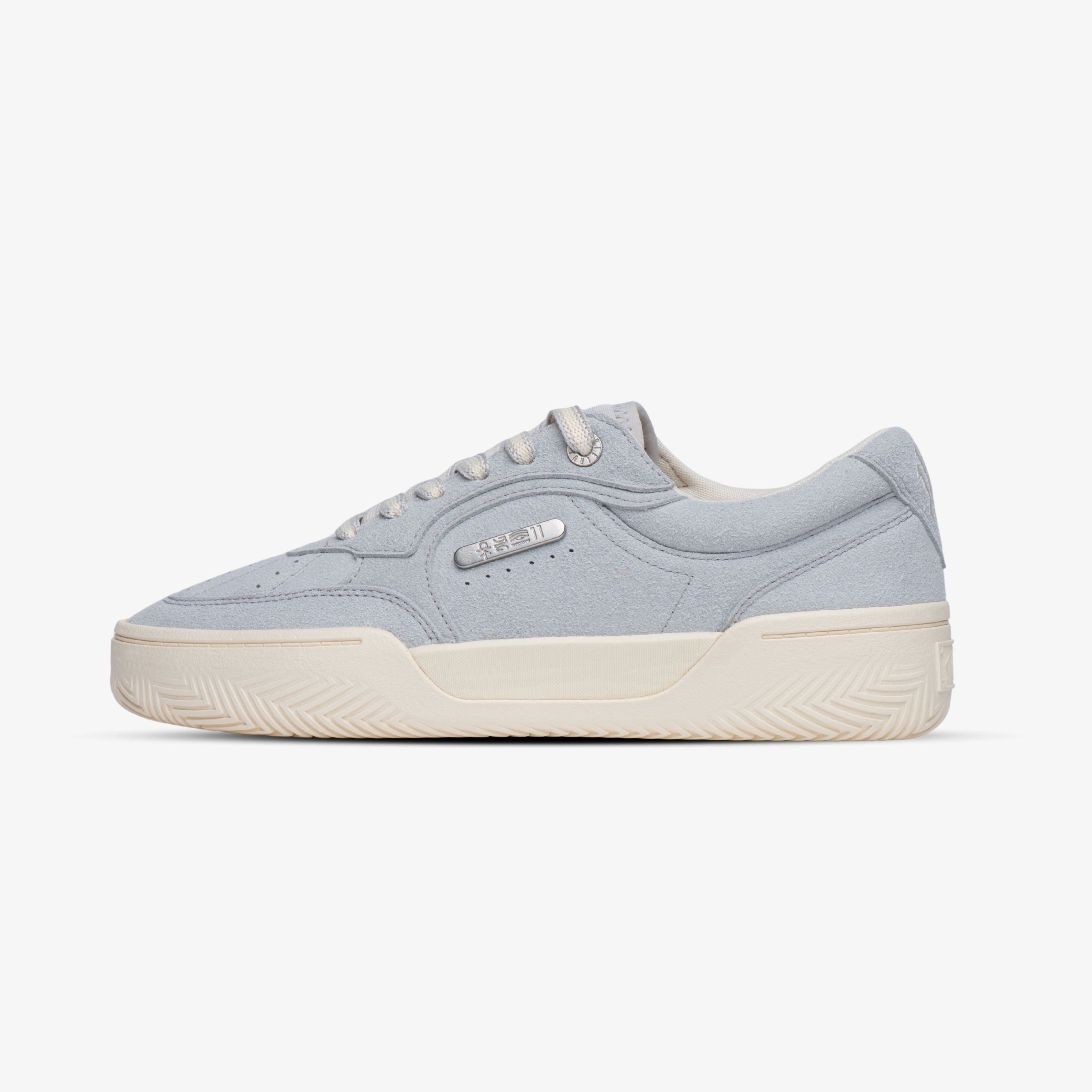 Side profile of a light grey low-top sneaker with cream rubber sole and tonal laces, featuring a minimalist retro design ideal for men’s casual or streetwear outfits, on a white background.
